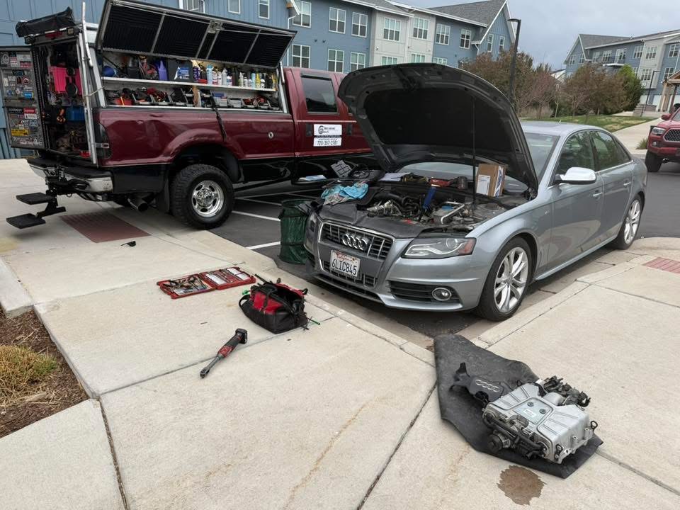 Denver Motors driveway car repair setup with tools