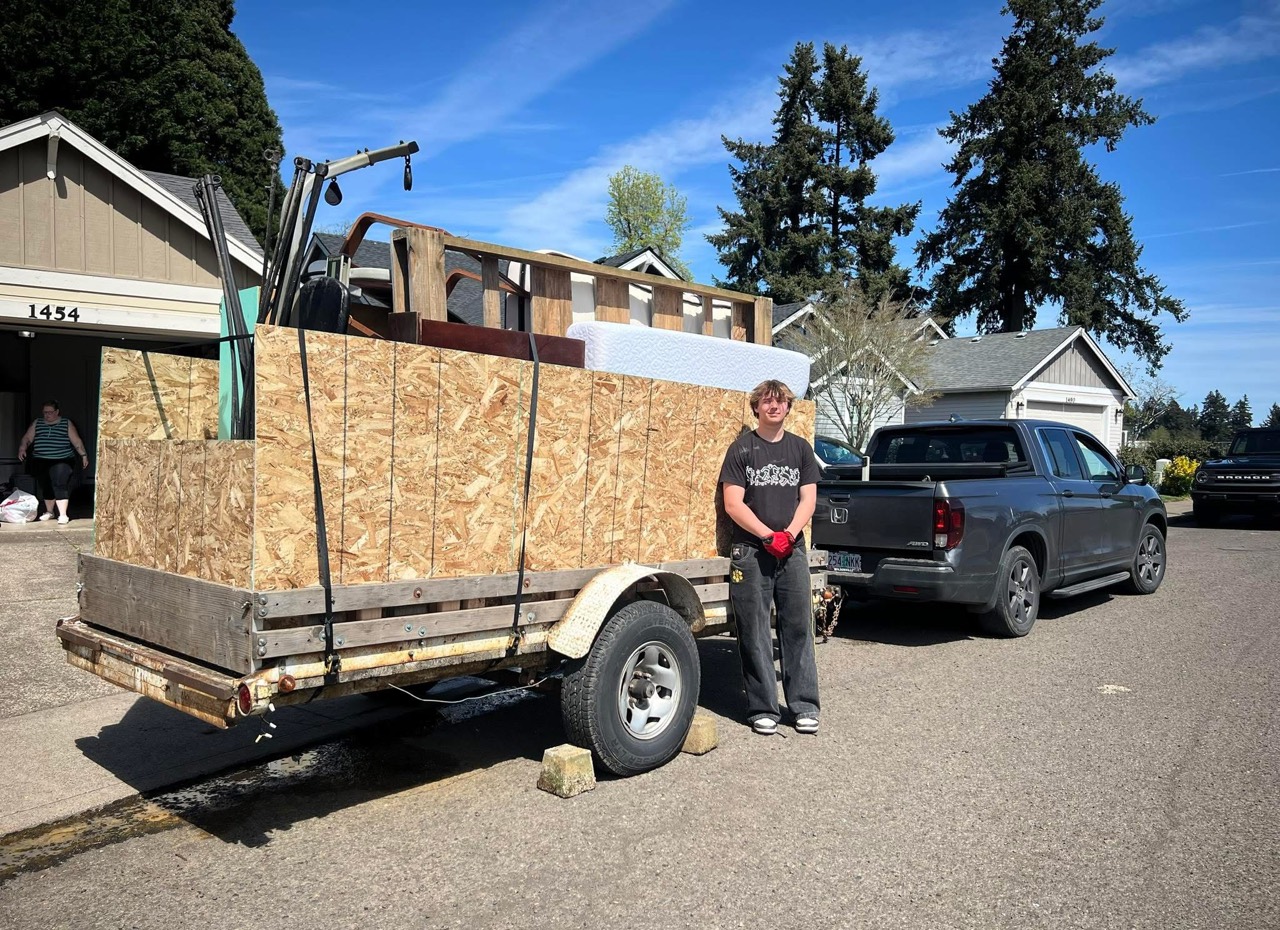 Loaded trailer parked in a West Linn neighborhood for junk removal
