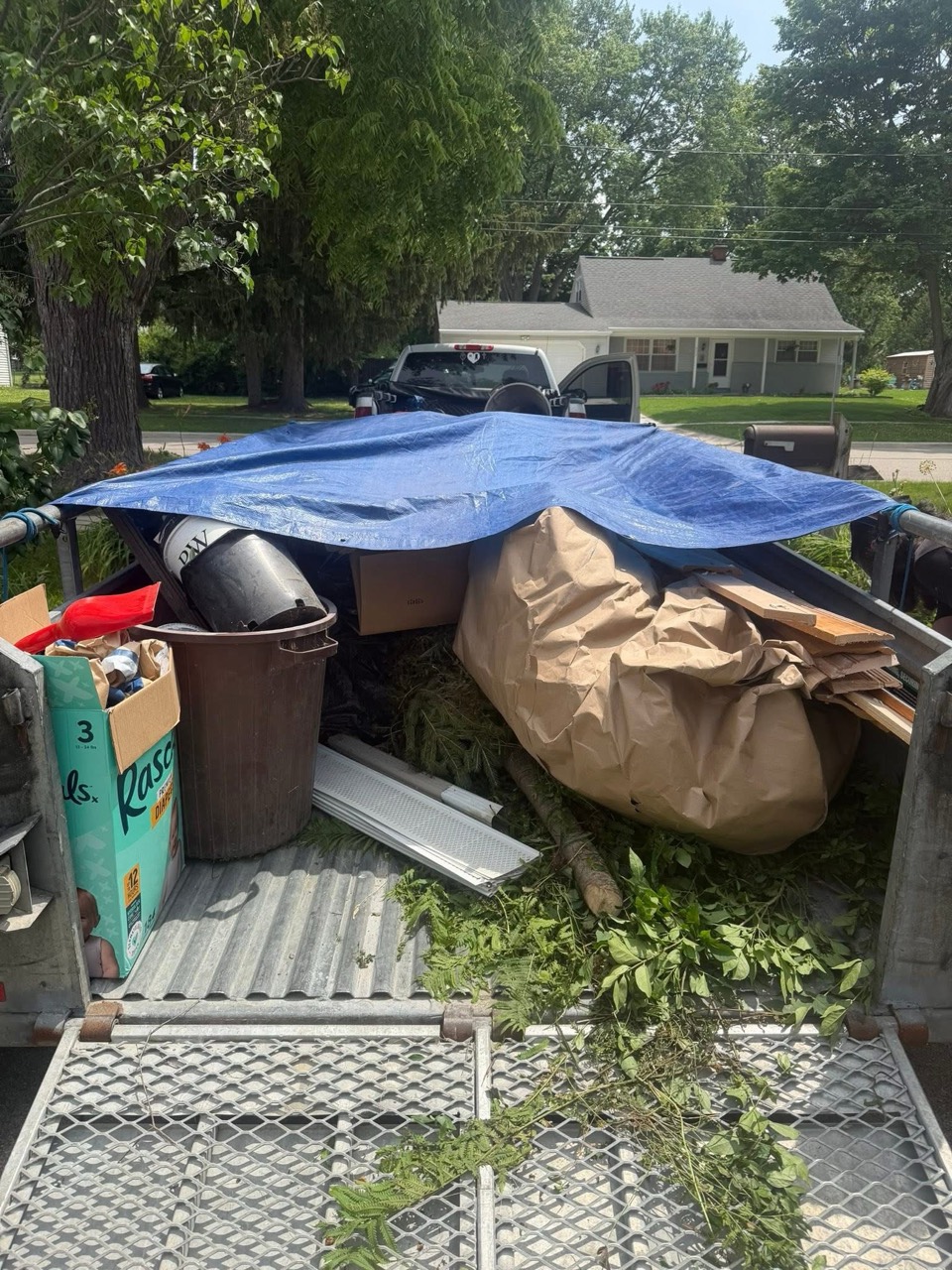 Trailer loaded with yard waste and junk removal debris